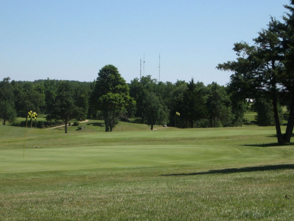 Course greens with trees in the background