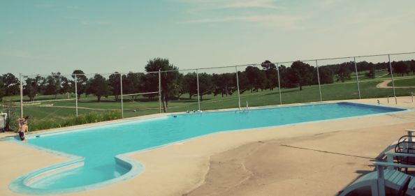 Swimming pool with a view of the golf course in the background 